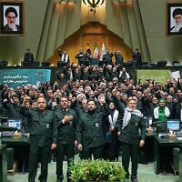 Iranian parliament members wear Islamic Revolutionary Guard Corps uniforms and chant 'Death to America' during a session in Tehran on February 1, 2026. (ICANA NEWS AGENCY / AFP)