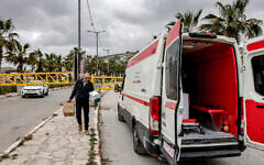 Illustrative: A man transports boxes of medication from Nablus's Rafidiya hospital to an ambulance vehicle waiting behind a barrier at the entrance to the Palestinian village of Turmus Ayya in the West Bank, on May 6, 2026. (Zain JAAFAR / AFP)