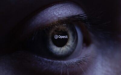 This illustration photograph taken with a macro lens shows an 'OpenAI' logo reverse projected onto a human eye at a studio in Paris on June 6, 2023. (JOEL SAGET / AFP)