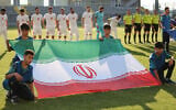 Iran's players stand behind the flag of Iran for photographers before the start of an international friendly soccer match between Iran and Gambia, in Antalya, southern Turkey, on May 29, 2026, as part of the team's preparation for the upcoming football World Cup. (Oner San/AFP)