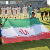 Iran's players stand behind the flag of Iran for photographers before the start of an international friendly soccer match between Iran and Gambia, in Antalya, southern Turkey, on May 29, 2026, as part of the team's preparation for the upcoming football World Cup. (Oner San/AFP)