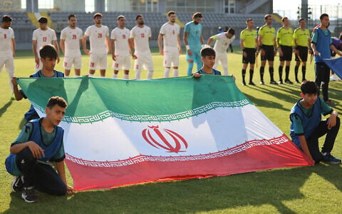 Iran's players stand behind the flag of Iran for photographers before the start of an international friendly soccer match between Iran and Gambia, in Antalya, southern Turkey, on May 29, 2026, as part of the team's preparation for the upcoming football World Cup. (Oner San/AFP)