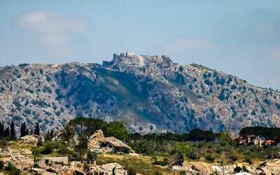 This picture taken from a position in the Upper Galilee region in northern Israel shows destroyed buildings in the southern Lebanese village of Kfar Kila and the medieval Beaufort Castle, in the background following an Israeli airstrike on May 31, 2026. (Jalaa MAREY / AFP)