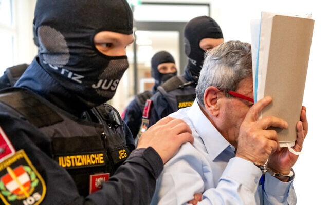 Ex-Syrian general defendant Khaled al-Halabi (R) covers his face as he is escorted in handcuffs for the trial to the courtroom by justice officers at the Regional Vienna's Court of Austria in Vienna, Austria, on June 1, 2026. (Joe Klamar/AFP) Ex-Syrian general defendant Khaled al-Halabi (R) covers his face as he is escorted in handcuffs for the trial to the courtroom by justice officers at the Regional Vienna's Court of Austria in Vienna, Austria, on June 1, 2026. (Joe Klamar/AFP)