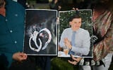 People hold images of victim Henry Nowak, and blood-covered handcuffs as they take part in a protest outside of Southampton Central Police Station in Southampton, southern England, on June 2, 2026, following his murder by Vickrum Digwa. (Justin Tallis/AFP)