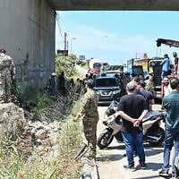 Lebanese soldiers and first responders inspect the site of an Israeli drone strike that reportedly killed the passengers of a vehicle on the Khalde highway at the southern entrance to Beirut on June 3, 2026. (FADEL itani / AFP)