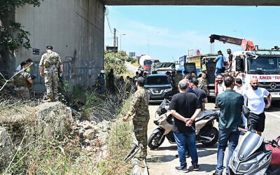 Lebanese soldiers and first responders inspect the site of an Israeli drone strike that reportedly killed the passengers of a vehicle on the Khalde highway at the southern entrance to Beirut on June 3, 2026. (FADEL itani / AFP)