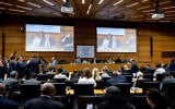 The Chairperson of the IAEA's Board of Governors for 2025-2026 David Grainge Biggs, who is also Australia's Resident Representative to the IAEA, seen on two screens (C) as he opens the International Atomic Energy Agency (IAEA) Board of Governors' Meeting at the agency's headquarters in Vienna, Austria on June 8, 2026. (Joe Klamar / AFP)