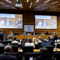 The Chairperson of the IAEA's Board of Governors for 2025-2026 David Grainge Biggs, who is also Australia's Resident Representative to the IAEA, seen on two screens (C) as he opens the International Atomic Energy Agency (IAEA) Board of Governors' Meeting at the agency's headquarters in Vienna, Austria on June 8, 2026. (Joe Klamar / AFP)