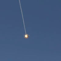 This picture taken from a position in the Upper Galilee region in northern Israel shows an Israeli Iron Dome missile streaking across the sky to intercept incoming projectiles on June 8, 2026 (Jalaa MAREY / AFP)