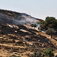 Smoke rises after Israeli settlers allegedly set fire to agricultural fields surrounding the village of Taybeh, in the West Bank on June 10, 2026. (Zain JAAFAR / AFP)