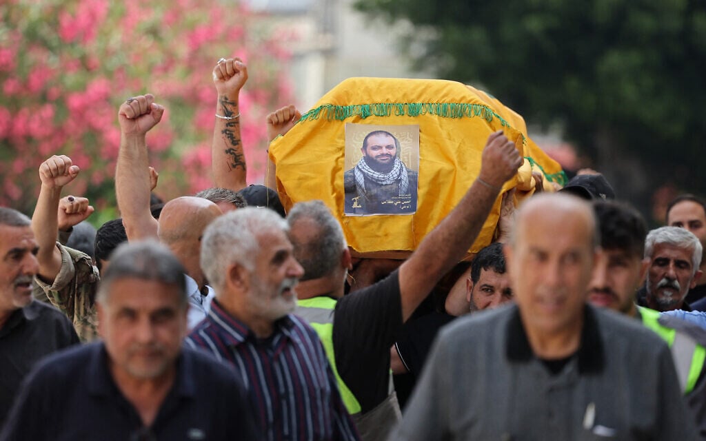 Mourners carry the coffin of Hezbollah operative Hassan Ali Kallas, from the southern Lebanese village of Nabatieh al Fawka, during his funeral at a temporary cemetery in the southern coastal Lebanese city of Sidon, on June 11, 2026. (Anwar AMRO / AFP)