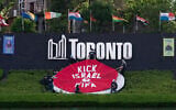 Activists place a banner covering the logo of the FIFA World Cup 2026 with the words "Kick Israel out of FIFA" in Toronto, Canada, June 12, 2026. (Jorge UZON / AFP)