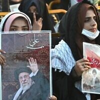 Activists carry portraits of Iran's slain supreme leader Ayatollah Ali Khamenei, as they pay tribute in Lahore, Pakistan, on June 13, 2026. (Arif Ali / AFP)