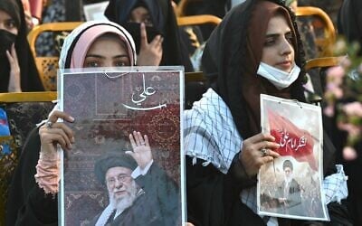 Activists carry portraits of Iran's slain supreme leader Ayatollah Ali Khamenei, as they pay tribute in Lahore, Pakistan, on June 13, 2026. (Arif Ali / AFP)