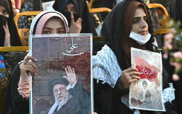 Activists carry portraits of Iran's slain supreme leader Ayatollah Ali Khamenei, as they pay tribute in Lahore, Pakistan, on June 13, 2026. (Arif Ali / AFP)