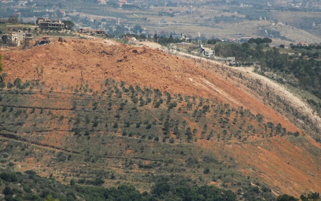 A photograph taken from the southern village of Ghandouriyeh on June 16, 2026, shows ejecta scattered around a crater reportedly left by the Israeli detonation of a Hezbollah tunnel network in Qantara (Kawnat HAJU / AFP)