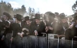 Security forces stand guard as ultra-Orthodox Jews gather to protest against the detention of Haredi draft evaders outside the Bet Lid military prison in Kfar Yona on June 17, 2026. (Ilia Yefimovich/AFP)