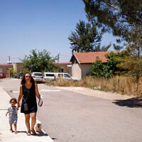 A woman and child walk in Ramat Trump (Trump Heights) in the Golan Heights on June 19, 2026 (Jalaa MAREY / AFP)