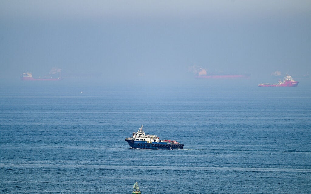 Cargo ships are pictured off the coast of the Khor Fakkan Container Terminal, the only natural deep-sea port in the region and one of the major container ports in Sharjah Emirate, along the Gulf of Oman on June 19, 2026 (AFP)