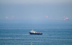 Cargo ships are pictured off the coast of the Khor Fakkan Container Terminal, the only natural deep-sea port in the region and one of the major container ports in Sharjah Emirate, along the Gulf of Oman on June 19, 2026 (AFP)