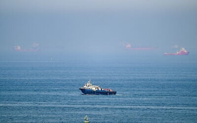 Cargo ships are pictured off the coast of the Khor Fakkan Container Terminal, the only natural deep-sea port in the region and one of the major container ports in Sharjah Emirate, along the Gulf of Oman on June 19, 2026 (AFP)