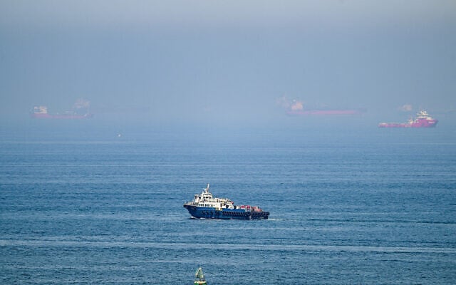 Cargo ships are pictured off the coast of the Khor Fakkan Container Terminal, the only natural deep-sea port in the region and one of the major container ports in Sharjah Emirate, along the Gulf of Oman on June 19, 2026 (AFP)
