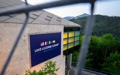 A sign is seen at the Burgenstock luxury hotel complex above Lake Lucerne, where talks following up on a deal to end the Middle East conflict are scheduled to begin, on June 21, 2026 (Fabrice COFFRINI / AFP)