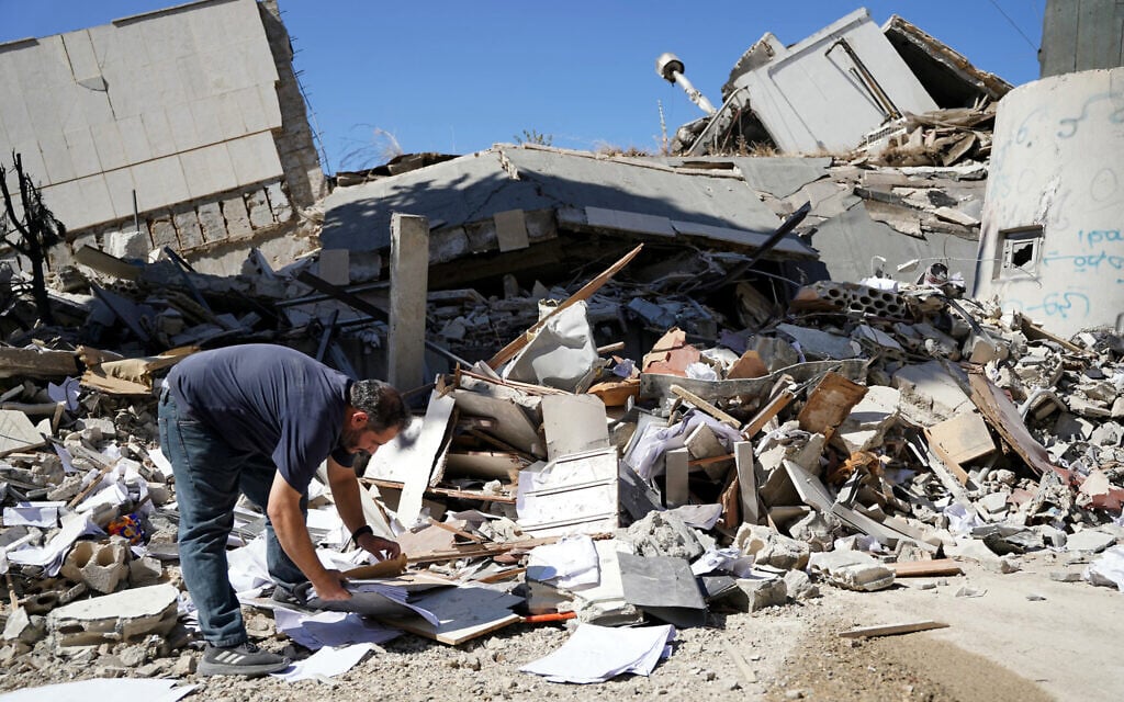 A man inspects the damage at the site of Lebanon's central bank building that was targeted in an Isreali strike the previous day in the southern Lebanese city of Nabatieh on June 21, 2026. (Abbas FAKIH / AFP) /