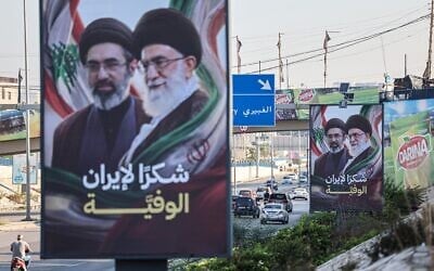 Cars and motorbikes drive past billboards showing Iran's Supreme Leader Ayatollah Mojtaba Khamenei (L) and his late father Ali Khamenei (R), with the slogan 'Thank you, loyal Iran,' in Beirut on June 22, 2026. (Anwar AMRO / AFP) Cars and motorbikes drive past billboards showing Iran's Supreme Leader Ayatollah Mojtaba Khamenei (L) and his late father Ali Khamenei (R), with the slogan 'Thank you, loyal Iran,' in Beirut on June 22, 2026. (Anwar AMRO / AFP)
