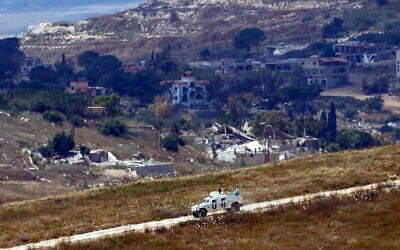 This picture taken from a position in northern Israel, near the border with Lebanon shows a United Nations Interim Force in Lebanon (UNIFIL) armored vehicle driving past destroyed buildings in southern Lebanon on June 22, 2026. (Jalaa MAREY / AFP) / This picture taken from a position in northern Israel, near the border with Lebanon shows a United Nations Interim Force in Lebanon (UNIFIL) armored vehicle driving past destroyed buildings in southern Lebanon on June 22, 2026. (Jalaa MAREY / AFP) /