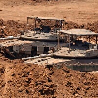 This picture taken from a position in the Upper Galilee in northern Israel shows Israeli tanks positioned along the border with southern Lebanon on June 22, 2026. (Jalaa MAREY / AFP)