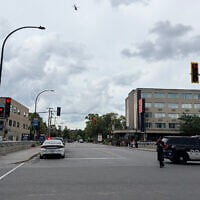 Police and a police vehicle are seen near the scene of a shooting in Montreal on June 22, 2026, which left two people dead, in addition to the attacker. (Daphné Lemelin/AFP)