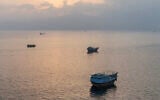 This aerial photograph shows boats anchored off Oman's northern Musandam Peninsula near the Strait of Hormuz on June 27, 2026. (AFP)