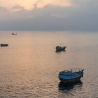 This aerial photograph shows boats anchored off Oman's northern Musandam Peninsula near the Strait of Hormuz on June 27, 2026. (AFP)