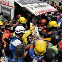 Rescuers load a person onto an ambulance after being pulled alive from the rubble of a collapsed building in Caraballeda, La Guaira state, Venezuela, on June 28, 2026, following back-to-back earthquakes. (Mauricio Valenzuela/AFP)