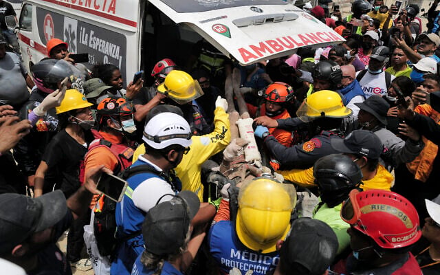 Rescuers load a person onto an ambulance after being pulled alive from the rubble of a collapsed building in Caraballeda, La Guaira state, Venezuela, on June 28, 2026, following back-to-back earthquakes. (Mauricio Valenzuela/AFP) Rescuers load a person onto an ambulance after being pulled alive from the rubble of a collapsed building in Caraballeda, La Guaira state, Venezuela, on June 28, 2026, following back-to-back earthquakes. (Mauricio Valenzuela/AFP)