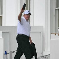 US President Donald Trump holds up his phone as he returns to the White House in Washington, DC on June 28, 2026 after spending time at Trump National Golf Club in Sterling, Virginia. (Kent NISHIMURA / AFP)