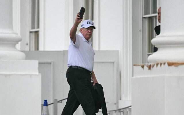 US President Donald Trump holds up his phone as he returns to the White House in Washington, DC on June 28, 2026 after spending time at Trump National Golf Club in Sterling, Virginia. (Kent NISHIMURA / AFP)