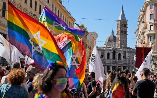 Illustrative: People hoist Pride flags emblazoned with a Star of David at the annual Pride parade in Rome, Italy, on June 26, 2021. (AP Photo/Gregorio Borgia)