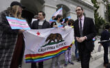 California State Sen. Scott Wiener, right, prepares to announce his proposed measure to provide legal refuge to displaced transgender youth and their families during a news conference in Sacramento, California, March 17, 2022. (AP Photo/Rich Pedroncelli, File)