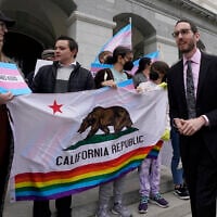 California State Sen. Scott Wiener, right, prepares to announce his proposed measure to provide legal refuge to displaced transgender youth and their families during a news conference in Sacramento, California, March 17, 2022. (AP Photo/Rich Pedroncelli, File)