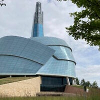 People walk by the Canadian Museum for Human Rights, created by internationally renowned architect Antoine Predock on August 13, 2023, in Winnipeg, Manitoba. (AP Photo/Felicia Fonseca)