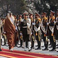 Qatar's Emir Sheikh Tamim bin Hamad Al-Thani, third left, reviews an honour guard as he is welcomed by Iran's President Masoud Pezeshkian, left, during his official welcoming ceremony at the Saadabad Palace in Tehran, Iran, February 19, 2025. (Iranian Presidency Office via AP)