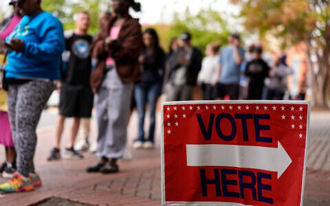 People stand in line during the last day of early voting, November 2, 2024, in Charlotte, North Carolina. (AP Photo/Mike Stewart, file)