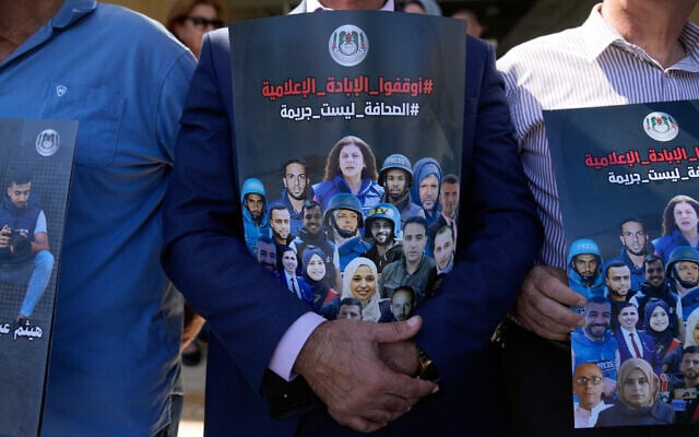 Illustrative: Palestinian journalists carry posters with pictures of colleagues who were killed by Israeli forces, in front of the United Nations office in the West Bank city of Ramallah on October 8, 2025. (AP Photo/Nasser Nasser) Illustrative: Palestinian journalists carry posters with pictures of colleagues who were killed by Israeli forces, in front of the United Nations office in the West Bank city of Ramallah on October 8, 2025. (AP Photo/Nasser Nasser)