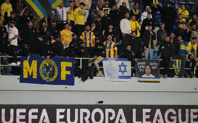 Maccabi fans watch the Europa League opening phase soccer match between Maccabi Tel Aviv and Midtjylland in Backa Topola, Serbia, Thursday, Oct. 23, 2025. (AP Photo/Darko Vojinovic)