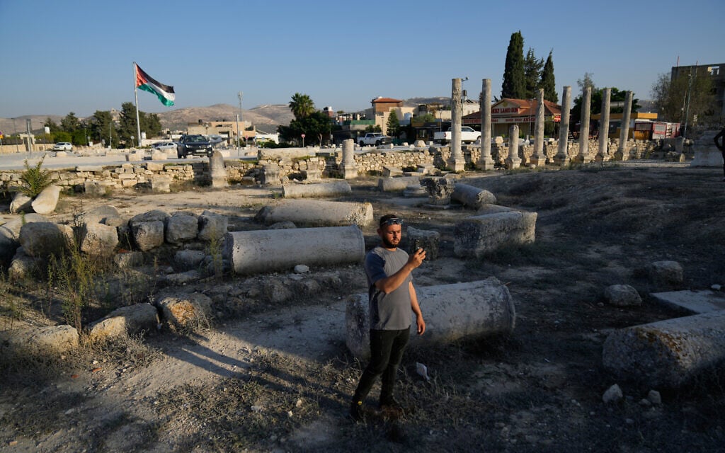 A Palestinian visitor takes a photo at the Roman archeological site in the West Bank town of Sebastia, November. 20, 2025. (AP Photo/Nasser Nasser)
