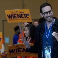 California State Senator Scott Wiener, right, smiles before taking photos with supporters at the 2026 California Democratic Party State Convention in San Francisco, February 21, 2026. (AP Photo/Jeff Chiu)