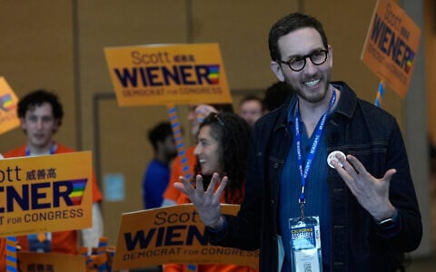 California State Senator Scott Wiener, right, smiles before taking photos with supporters at the 2026 California Democratic Party State Convention in San Francisco, February 21, 2026. (AP Photo/Jeff Chiu)
